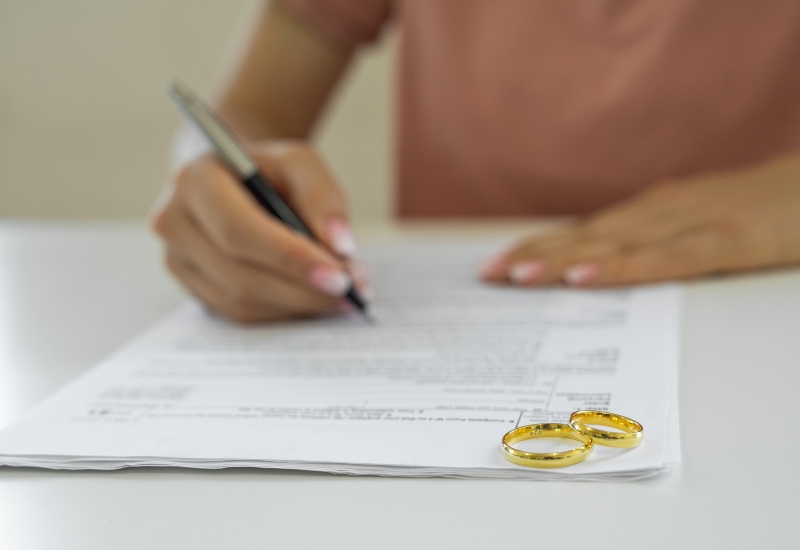 A Woman Signing Her Divorce Papers in Tucson, AZ & Pima County