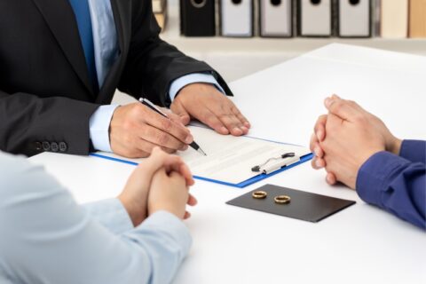 Couple Signing Divorce Papers with Lawyers in Tucson, AZ & Pima County