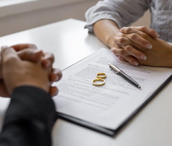 Dissolution of marriage paperwork and wedding rings on a desk